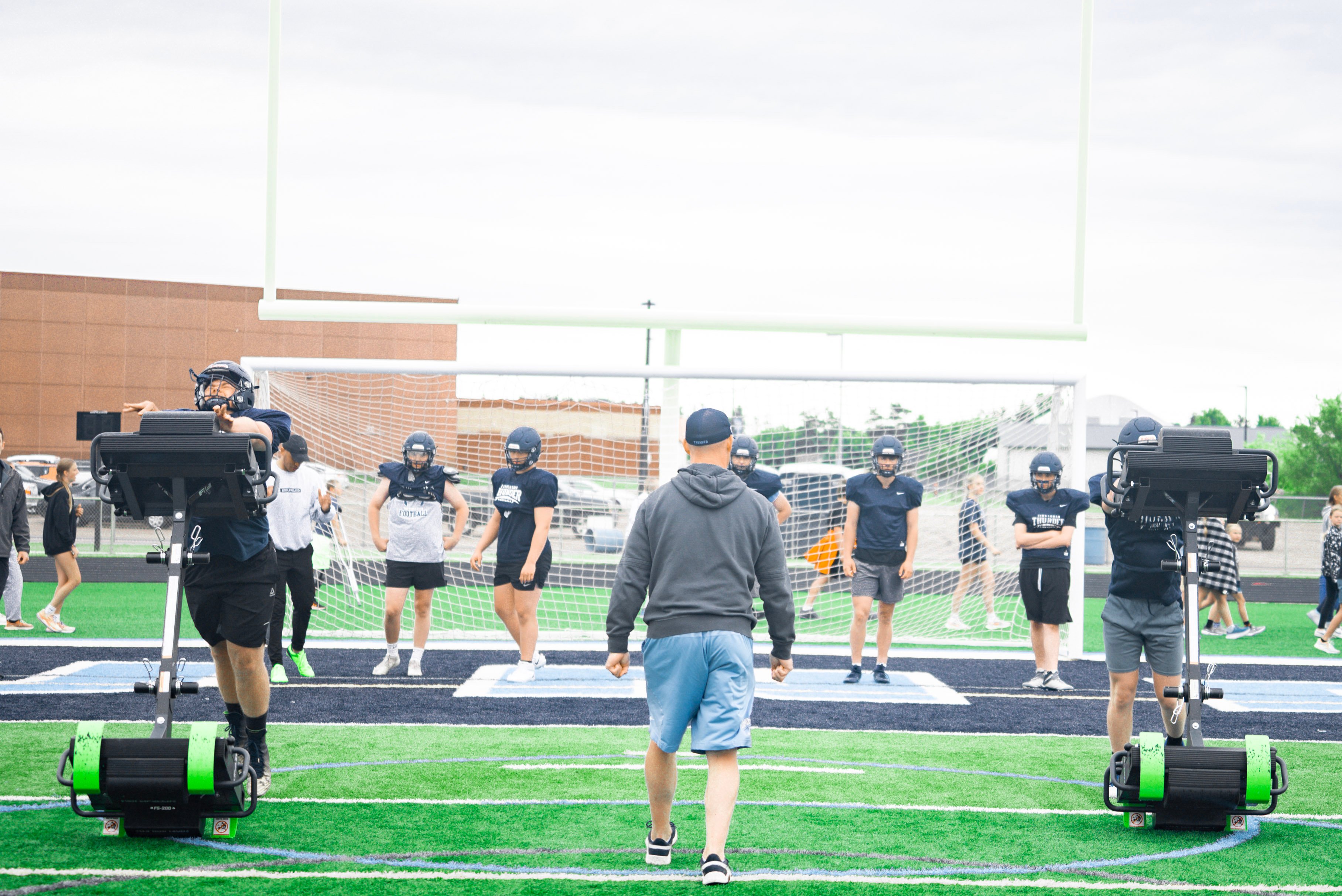 Coach teaching his players how to use The FlipSled and practicing his controlled speaking delivery in practice.